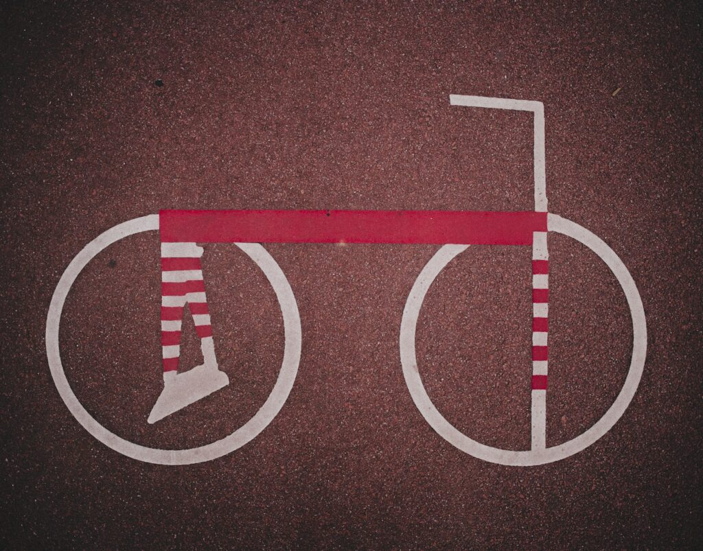 Stylized bicycle with striped wheels and frame.